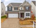 Two story brick home with a three car garage and landscaping at 3064 Virginia Trail Ct, Fort Mill, SC 29715