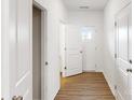 Hallway with wooden floors and white doors creating a neat modern feel at 4031 Lawnview Dr, Charlotte, NC 28269