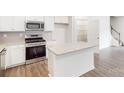 Modern kitchen features a granite island, stainless steel appliances, and ample cabinet space at 4031 Lawnview Dr, Charlotte, NC 28269