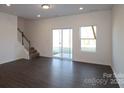 Spacious living room with modern flooring and a sliding glass door for seamless indoor-outdoor living at 4031 Lawnview Dr, Charlotte, NC 28269