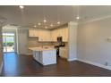 Bright, modern kitchen featuring white cabinets, a center island, and stainless steel appliances at 5548 Stafford Rd # 29, Charlotte, NC 28215