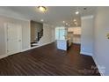 Spacious living room with stairs and a modern kitchen in the background at 5548 Stafford Rd # 29, Charlotte, NC 28215