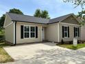 A lovely single-story home features a concrete driveway, well-maintained lawn, and classic black shuttered windows at 718 Park Ave, Salisbury, NC 28144