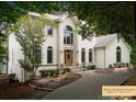 Two story home with white exterior and landscaping at 800 Lakeview Shores Loop, Mooresville, NC 28117