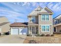 Inviting two-story home with stone accents, a two-car garage, and manicured front yard at 980 Von Buren Blvd, Rock Hill, SC 29730