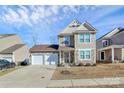 Attractive two-story home with a stone-accented facade, two-car garage, and tidy landscaping at 980 Von Buren Blvd, Rock Hill, SC 29730