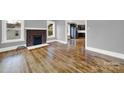 Spacious living room with gleaming hardwood floors and classic brick fireplace at 306 S Jones Ave, Rock Hill, SC 29730