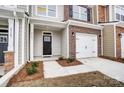 Front entry of townhome with walkway, landscaping and attached garage at 4153 Black Ct # 173, Harrisburg, NC 28075