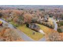 Aerial shot of a brick home nestled amongst trees in a residential neighborhood at 4687 Snow Dr, Harrisburg, NC 28075