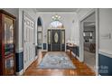 Welcoming foyer with hardwood floors, chandelier, and view into adjacent rooms at 4687 Snow Dr, Harrisburg, NC 28075