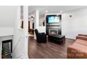 Modern living room featuring a cozy fireplace, sleek furniture, and stylish decor at 7108 Founders Club Ct, Charlotte, NC 28269