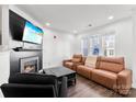 Contemporary living area showcasing a fireplace, comfortable seating, and a well-lit ambiance at 7108 Founders Club Ct, Charlotte, NC 28269