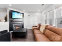 Bright and airy living room with large windows, a fireplace, and a comfortable sofa at 7108 Founders Club Ct, Charlotte, NC 28269