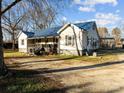 Ranch home with blue metal roof, covered porch, and large yard at 10310 Stokes Ferry Rd, Gold Hill, NC 28071