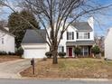 Two-story house with white siding, gray roof, and red front door at 11813 Fox Glen Rd, Charlotte, NC 28269