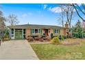 Ranch home with green door and landscaped yard at 663 14Th Nw Ave, Hickory, NC 28601