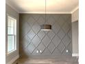 Modern dining room features a statement wall with geometric molding and a stylish pendant light fixture at 143 Dabbling Duck Cir, Mooresville, NC 28117