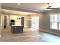 Bright open floorplan with a kitchen island, sliding glass doors, and modern finishes throughout the living area at 143 Dabbling Duck Cir, Mooresville, NC 28117