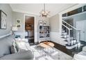 Inviting living room with a gray sofa, decorative pillows, stylish decor, and dark hardwood floors at 2315 Smith Harbour Dr, Denver, NC 28037