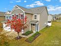 Two-story townhouse with gray siding, two-car garage, and landscaping at 2471 Palmdale Walk Dr # 107, Fort Mill, SC 29708