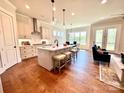 Open-concept kitchen with a center island, stainless steel appliances, and hardwood floors throughout at 2971 Alveston Nw Dr # 29, Concord, NC 28027