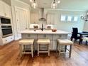Well-appointed kitchen with a large island and barstool seating, modern cabinets, and stylish fixtures at 2971 Alveston Nw Dr # 29, Concord, NC 28027