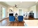 Bright living room with a fireplace, hardwood floors, and access to the outdoor space through double doors at 2971 Alveston Nw Dr # 29, Concord, NC 28027
