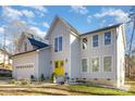 Two-story house with a yellow door, attached garage, and landscaping at 10221 Hanging Moss Trl, Mint Hill, NC 28227