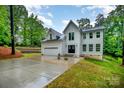 Lovely two-story home with a garage, a long driveway, and well-manicured front yard at 10221 Hanging Moss Trl, Mint Hill, NC 28227