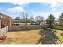 A spacious fenced backyard with mature trees and a grassy area at 2505 Ashford Dr, Newton, NC 28658