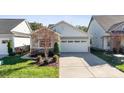 House exterior featuring a two-car garage and landscaping at 4779 Looking Glass Trl, Denver, NC 28037