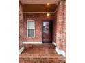 Brick front porch with a glass entry door and sidelights at 5846 Hanna Ct, Charlotte, NC 28212