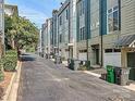 Row of townhomes with a paved alley and trash bins at 658 E 10Th St, Charlotte, NC 28202