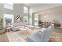 Bright and airy living room featuring large windows, modern furnishings, and an open floor plan at 18024 Wilbanks Dr, Charlotte, NC 28278