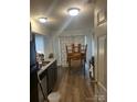 Kitchen area with granite counters, modern appliances, and a dining area with a table at 5334 Esther Ln, Charlotte, NC 28214