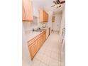 Functional kitchen featuring wood cabinets, white appliances, and tile flooring at 588 Blossom Hill Rd, Lincolnton, NC 28092