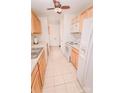 Functional kitchen featuring wood cabinets, white appliances, and tile flooring at 588 Blossom Hill Rd, Lincolnton, NC 28092