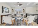 Open-concept living space with a modern aesthetic, featuring light-colored furniture and a stylish glass coffee table at 607 King Arthur Dr, Gastonia, NC 28056