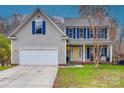 Inviting two-story home featuring blue shutters, a yellow front door, and an attached garage at 1345 Shimmer Light Cir, Rock Hill, SC 29732