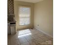 A kitchen area with tile flooring and a window at 1406 Milan Rd, Charlotte, NC 28216