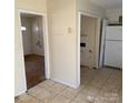 A kitchen area with tile flooring and views into other rooms at 1406 Milan Rd, Charlotte, NC 28216