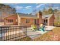 Back patio with seating area and fire pit at 1601 Bennington Nw Dr, Concord, NC 28027