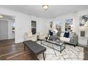 Bright living room features hardwood floors, comfy seating, and lots of natural light at 304 Gold Hill Ave, Rockwell, NC 28138