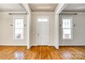 Bright and airy entryway with hardwood floors and tall windows at 5734 Morris Hunt Dr, Fort Mill, SC 29708