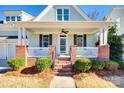 Inviting front porch with brick columns and white railings at 5734 Morris Hunt Dr, Fort Mill, SC 29708