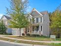 Two-story home with gray siding, stone accents, and a two-car garage at 9507 Inverness Bay Rd, Charlotte, NC 28278