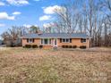 Classic brick ranch-style home with manicured lawn and mature trees and updated roof at 2319 Tin Mine Rd, Lincolnton, NC 28092