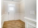Bright entryway with white trim, wood-look floors, and a front door at 4113 Black Ct # 167, Harrisburg, NC 28075