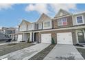 Three-unit townhome building, one unit available. Brick and siding exterior, two-car garages at 4113 Black Ct # 167, Harrisburg, NC 28075