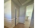 Bright foyer with wood flooring, white wainscoting, and view of kitchen at 4125 Black Ct # 169, Harrisburg, NC 28075